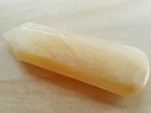 Highly polished Orange Calcite wand approximate height 70 mm Used in crystal healing and meditation. Excellent for collectors. Being a natural product this crystal may have natural blemishes and vary in colour. www.naturalhealingshop.co.uk based in Nuneaton for crystals, spiritual healing, meditation, relaxation, spiritual development,workshops.
