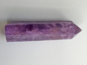 Amethyst polished point with cut base approx height 105 mm. Diameter 30 mm. Being a natural product the crystal may have natural blemishes and vary in colour. www.naturalhealingshop.co.uk based in Nuneaton for crystals, spiritual healing, meditation, relaxation, spiritual development,workshops.