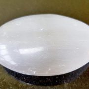 Highly polished Selenite palm stone 70 x 40 mm. The palm stones are made from the best grade rough materials to produce a well finished, highly polished product. Used by crystal healers and general therapists for massage and similar treatments. Also perfect for collectors. Being a natural product these stones may have natural blemishes and vary in colour and banding. www.naturalhealingshop.co.uk based in Nuneaton for crystals, spiritual healing, meditation, relaxation, spiritual development,workshops.