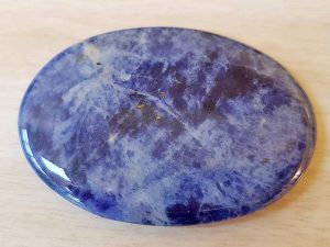 Highly polished Sodalite palm stone 70 x 40 mm. The palm stones are made from the best grade rough materials to produce a well finished, highly polished product. Used by crystal healers and general therapists for massage and similar treatments. Also perfect for collectors. Being a natural product these stones may have natural blemishes and vary in colour and banding. www.naturalhealingshop.co.uk based in Nuneaton for crystals, spiritual healing, meditation, relaxation, spiritual development,workshops.