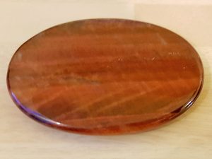Highly polished Red Tiger Eye palm stone 70 x 40 mm. The palm stones are made from the best grade rough materials to produce a well finished, highly polished product. Used by crystal healers and general therapists for massage and similar treatments. Also perfect for collectors. Being a natural product these stones may have natural blemishes and vary in colour and banding. www.naturalhealingshop.co.uk based in Nuneaton for crystals, spiritual healing, meditation, relaxation, spiritual development,workshops.