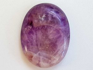 Highly polished Amethyst thumb stone 40 x 30 mm. The thumb stones have been designed to have a pleasing feel with the highest quality finish. They are shaped to fit beautifully between the thumb and fingers. Being a natural product these stones may have natural blemishes and vary in colour and banding. www.naturalhealingshop.co.uk based in Nuneaton for crystals, spiritual healing, meditation, relaxation, spiritual development,workshops.