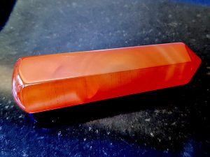 Highly polished Carnelian wand approximate height 70 mm Used in crystal healing and meditation. Excellent for collectors. Being a natural product this crystal may have natural blemishes and vary in colour. www.naturalhealingshop.co.uk based in Nuneaton for crystals, spiritual healing, meditation, relaxation, spiritual development,workshops.