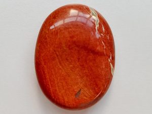 Highly polished red jasper thumb stone 40 x 30 mm. The thumb stones have been designed to have a pleasing feel with the highest quality finish. They are shaped to fit beautifully between the thumb and fingers. Being a natural product these stones may have natural blemishes and vary in colour and banding. www.naturalhealingshop.co.uk based in Nuneaton for crystals, spiritual healing, meditation, relaxation, spiritual development,workshops.