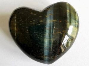 Highly polished Blue Tigers Eye Heart approx 45 mm. These hearts are perfect for a gift! There are purple velvet pouches or organza bags you can purchase to pop them into for the finishing touch. Being a natural product these stones may have natural blemishes and vary in colour and banding. www.naturalhealingshop.co.uk based in Nuneaton for crystals, spiritual healing, meditation, relaxation, spiritual development,workshops.