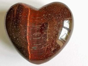 Highly polished Red Tigers Eye Heart approx 45 mm. These hearts are perfect for a gift! There are purple velvet pouches or organza bags you can purchase to pop them into for the finishing touch. Being a natural product these stones may have natural blemishes and vary in colour and banding. www.naturalhealingshop.co.uk based in Nuneaton for crystals, spiritual healing, meditation, relaxation, spiritual development,workshops.