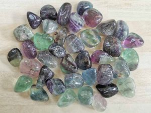 Highly polished Rainbow Fluorite tumble stone size 2-3 cm. Being a natural product these stones may have natural blemishes and vary in colour, banding and shape. See photograph. www.naturalhealingshop.co.uk based in Nuneaton for crystals, spiritual healing, meditation, relaxation, spiritual development,workshops.