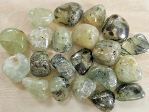 Highly polished Prehnite with Epidote tumble stone size 2-3 cm. Being a natural product these stones may have natural blemishes and vary in colour, banding and shape. See photograph. www.naturalhealingshop.co.uk based in Nuneaton for crystals, spiritual healing, meditation, relaxation, spiritual development,workshops.
