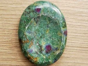Highly polished Ruby Zoisite thumb stone 40 x 30 mm. The thumb stones have been designed to have a pleasing feel with the highest quality finish. They are shaped to fit beautifully between the thumb and fingers. Being a natural product these stones may have natural blemishes and vary in colour and banding. www.naturalhealingshop.co.uk based in Nuneaton for crystals, spiritual healing, meditation, relaxation, spiritual development,workshops.