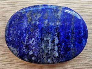 Highly polished Lapis Lazuli palm stone 70 x 40 mm. The palm stones are made from the best grade rough materials to produce a well finished, highly polished product. Used by crystal healers and general therapists for massage and similar treatments. Also perfect for collectors. Being a natural product these stones may have natural blemishes and vary in colour and banding. www.naturalhealingshop.co.uk based in Nuneaton for crystals, spiritual healing, meditation, relaxation, spiritual development,workshops.