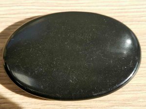 Highly polished shungite palm stone 70 x 40 mm. The palm stones are made from the best grade rough materials to produce a well finished, highly polished product. Used by crystal healers and general therapists for massage and similar treatments. Also perfect for collectors. Being a natural product these stones may have natural blemishes and vary in colour and banding. www.naturalhealingshop.co.uk based in Nuneaton for crystals, spiritual healing, meditation, relaxation, spiritual development,workshops.